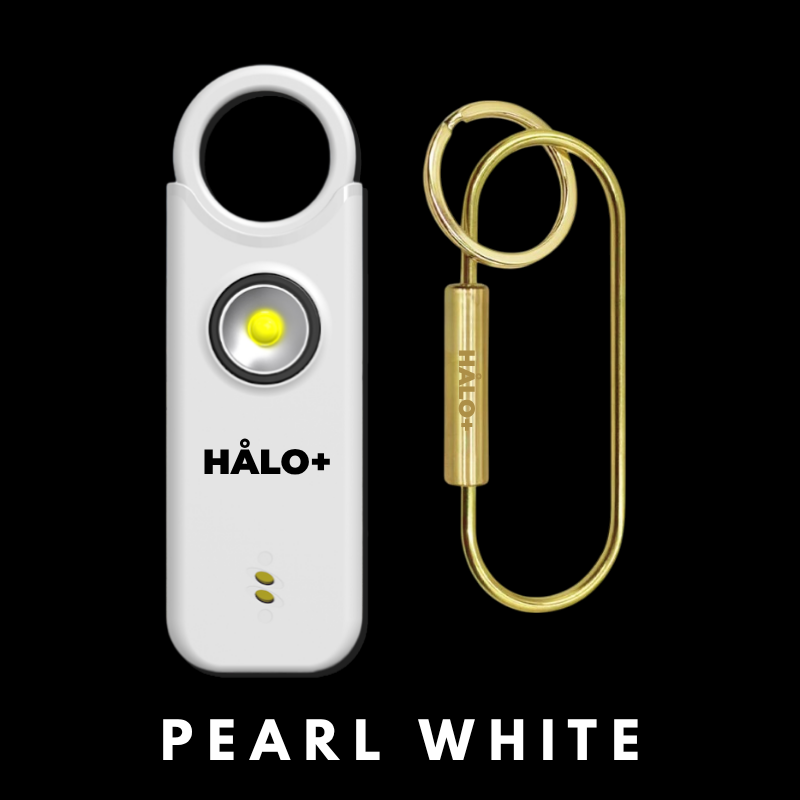 Pearl white HALO+ device with a gold keychain on a black background