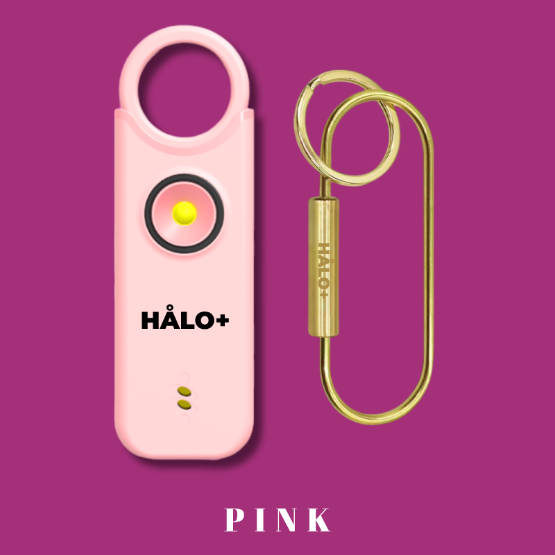 Pink HALO+ device with a gold keychain on a dark pink background